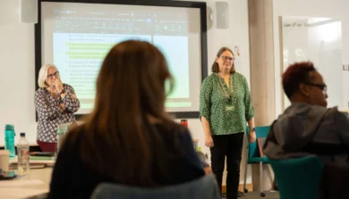 Backs of student in lecture facing lecturers
