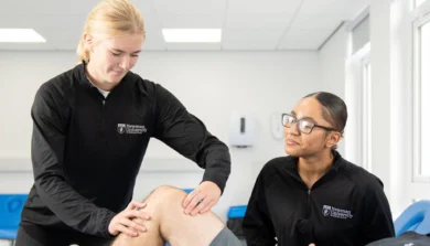 Two students at massage clinic at Birmingham Newman University