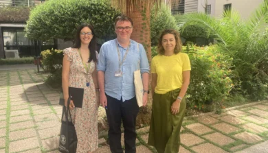 Image of outside Valencia campus gardens with 3 smiling people