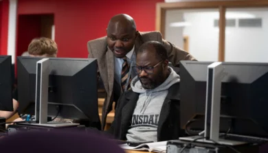 Accounting and Finance student with tutor in lecture computer room