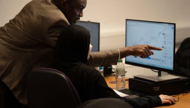 Accounting and Finance student with tutor in lecture computer room