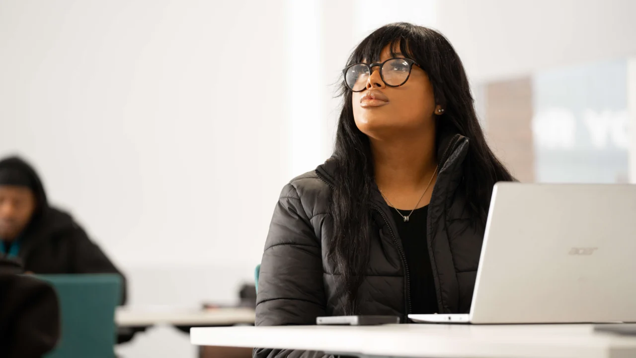 Business Management student in lecture with laptop