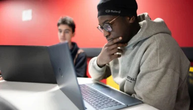 Computer Science student in class on laptop