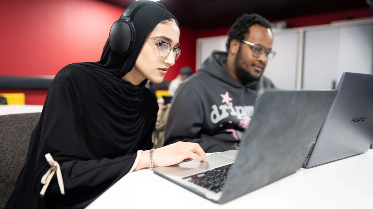 Computer Science students in class on laptop