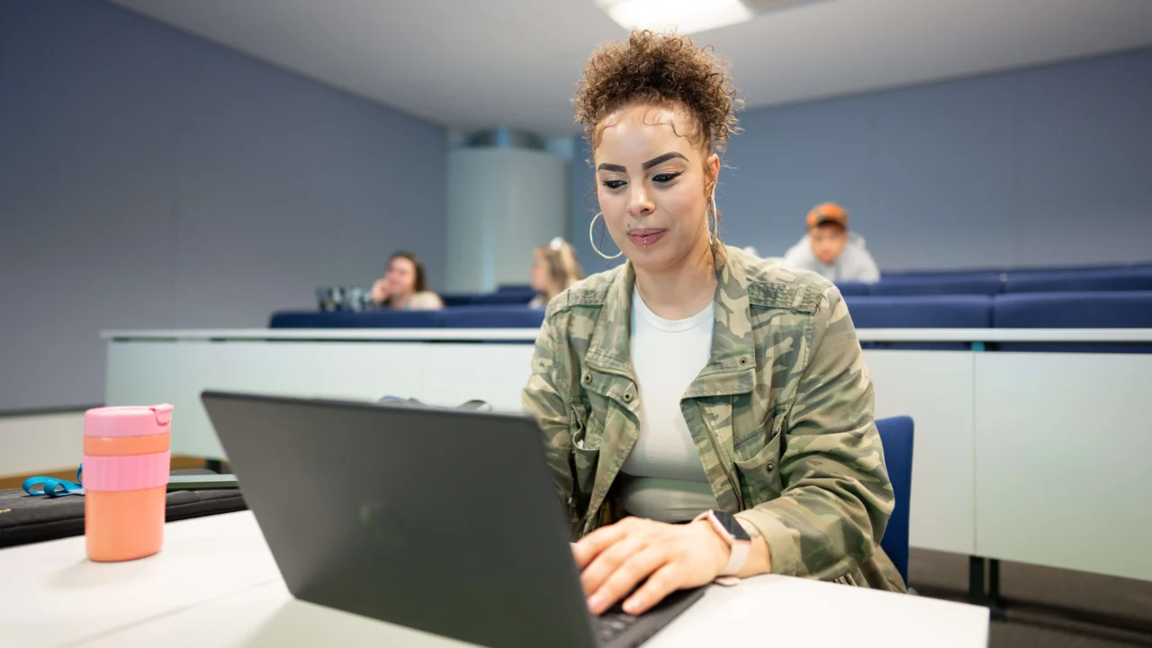 Computer Science student in class on laptop