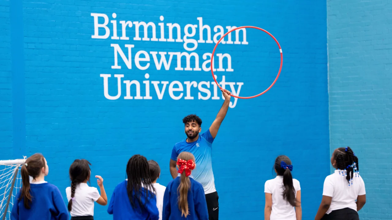 Sport Coaching lesson in gym with young children