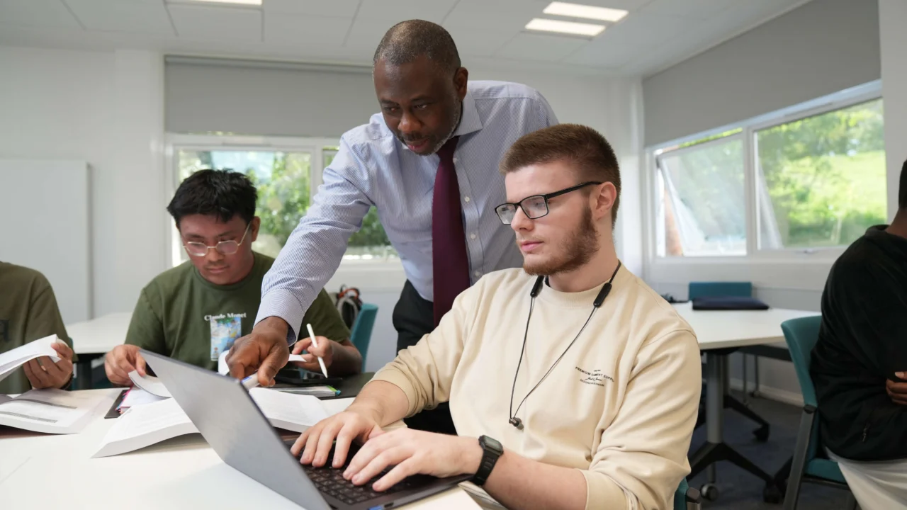 Business academic talking to students in class