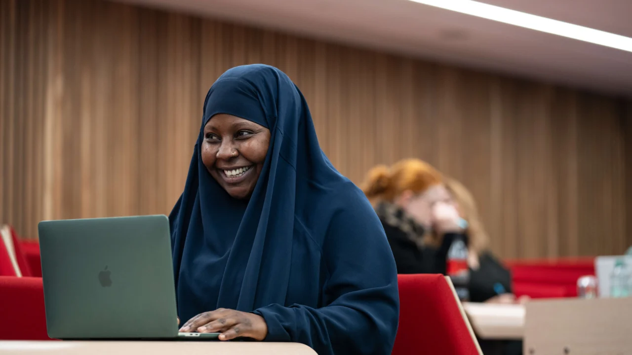 Education, Childhood and Professional Studies in lecture theatre with laptop