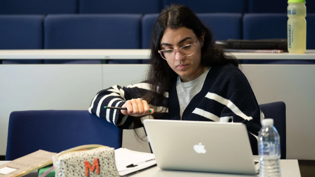 Education, Childhood and Professional Studies student in classroom with laptop