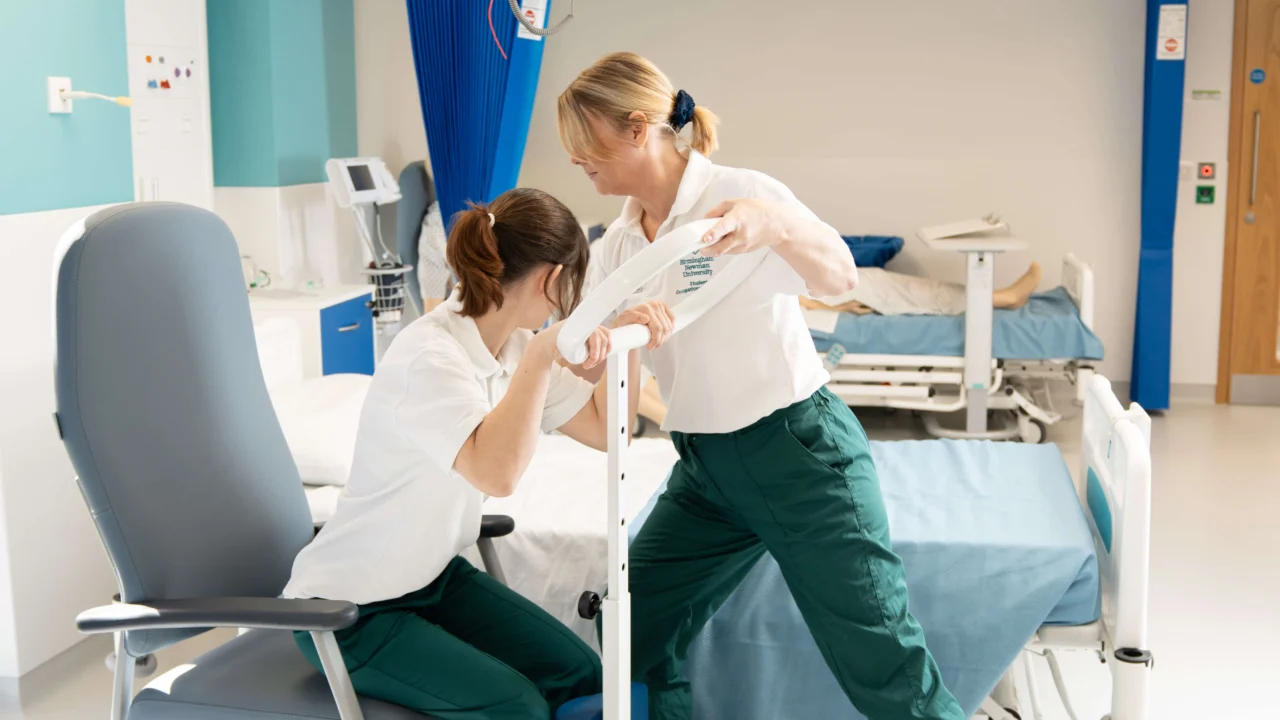 Physiotherapy helping someone out of a chair