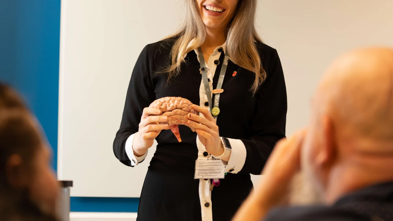 Psychology lecturer in classroom talking to students