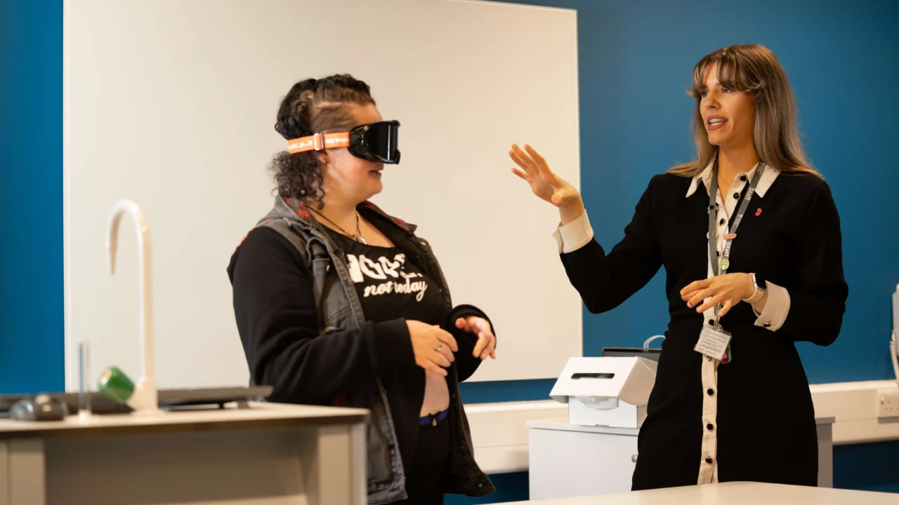 Psychology students with tutor doing a practical with goggles