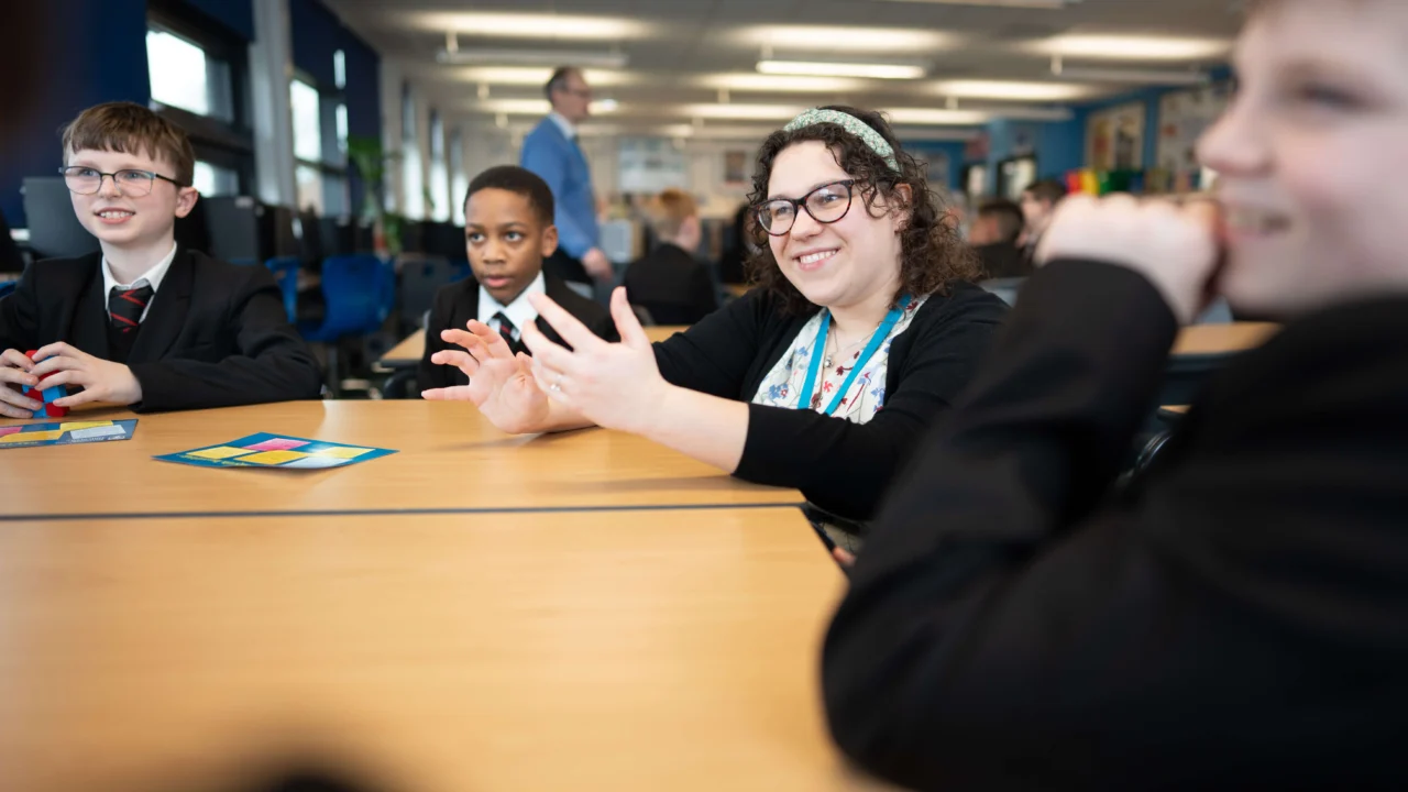 Secondary Education teacher in classroom with students