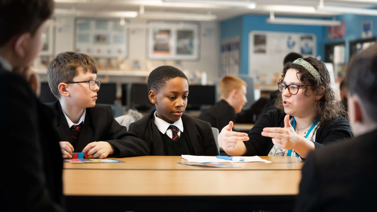 Secondary Education teacher in classroom with students