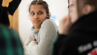 Student sitting in class with arms folded