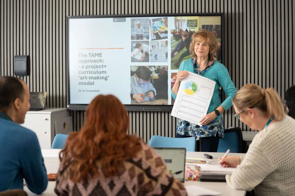 Teacher leading a lesson with students in a classroom.