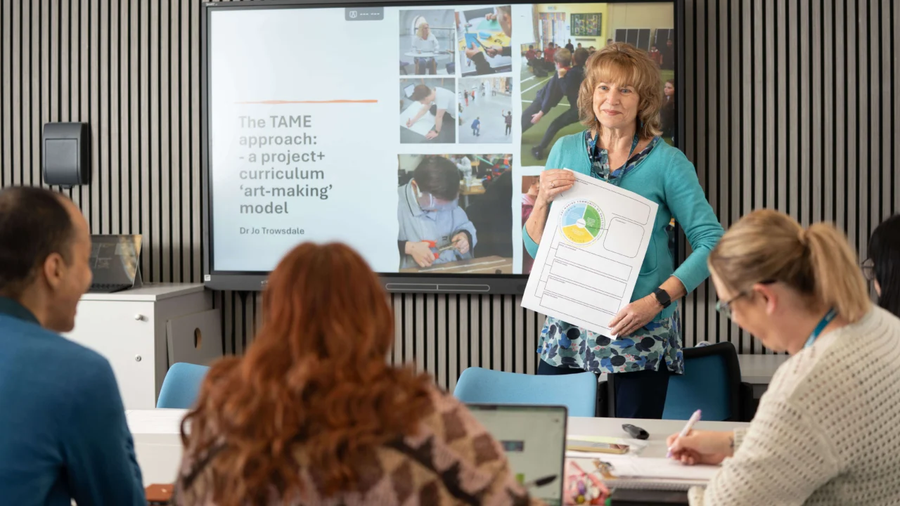 Teacher leading a lesson with students in a classroom.