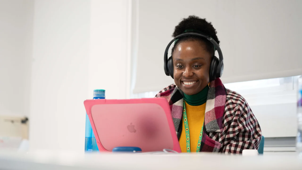 Student using laptop with headphones on