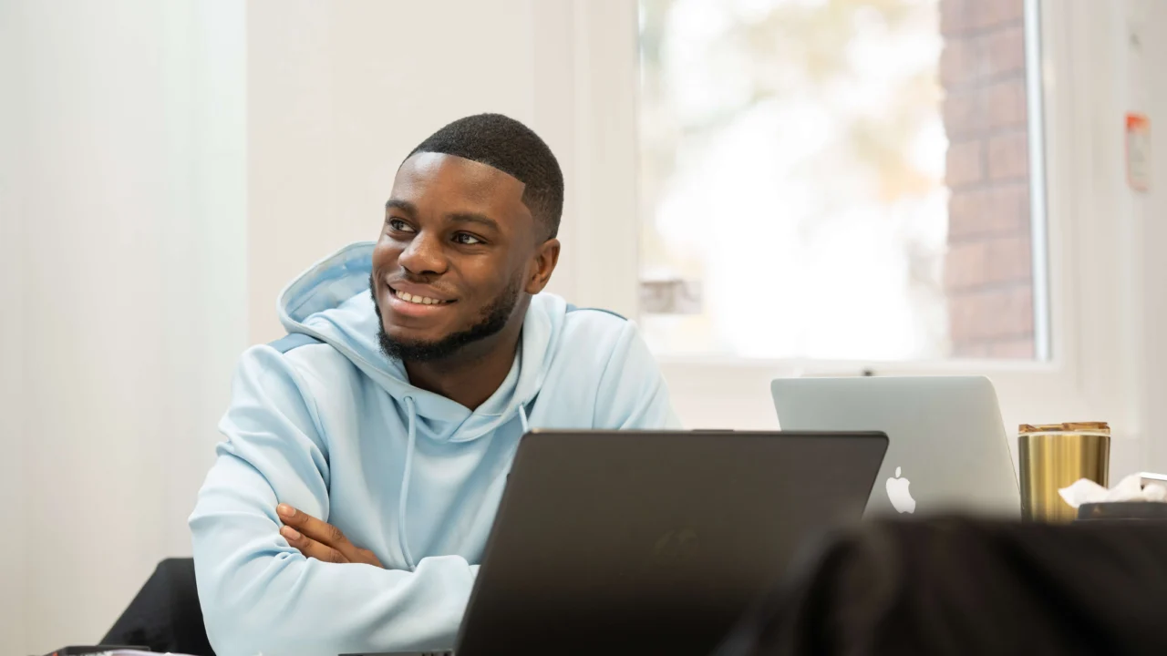 Student sitting in front of laptop in class