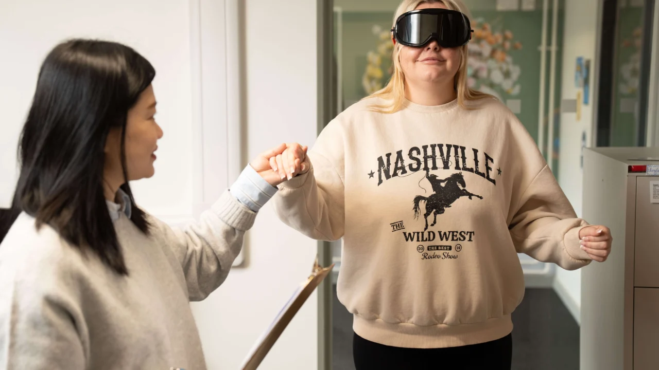 Psychology student taking part in experiment with professional goggles on