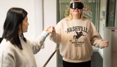 Psychology student taking part in experiment with professional goggles on