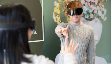 Psychology student taking part in experiment with professional goggles on