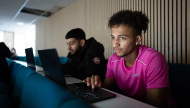 Students in lecture room using laptops