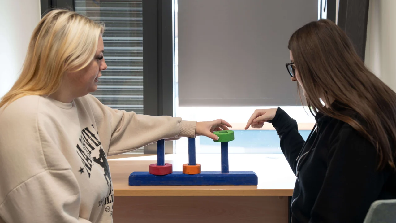 Two Developmental Science with Neurodiversity students working together on a table top puzzle