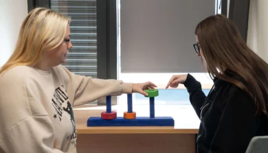 Two Developmental Science with Neurodiversity students working together on a table top puzzle