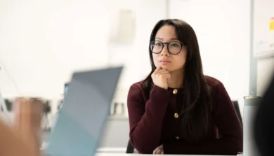 Student in class at table with laptop
