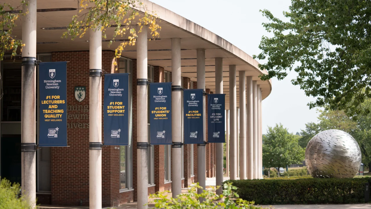 Front entrance of Birmingham Newman University with globe
