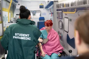 Paramedic student in ambulance with patient