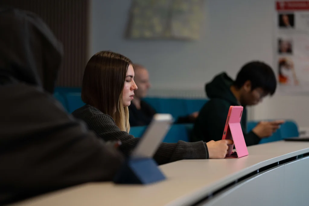 Student in lecture with laptop