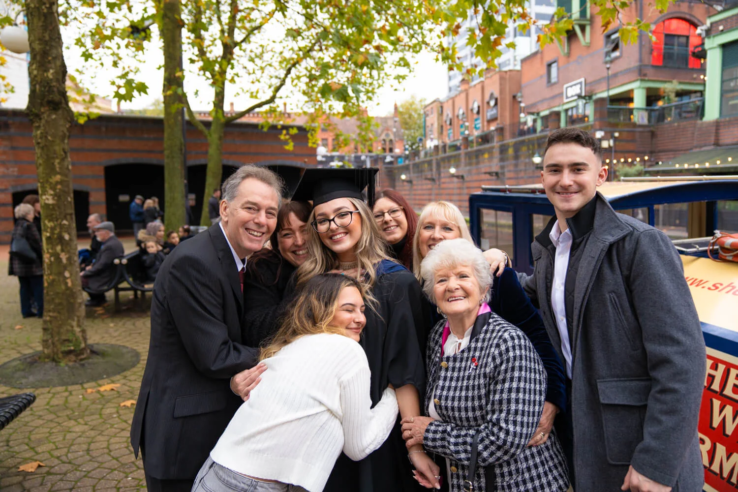 Family enjoying graduation outside near canal