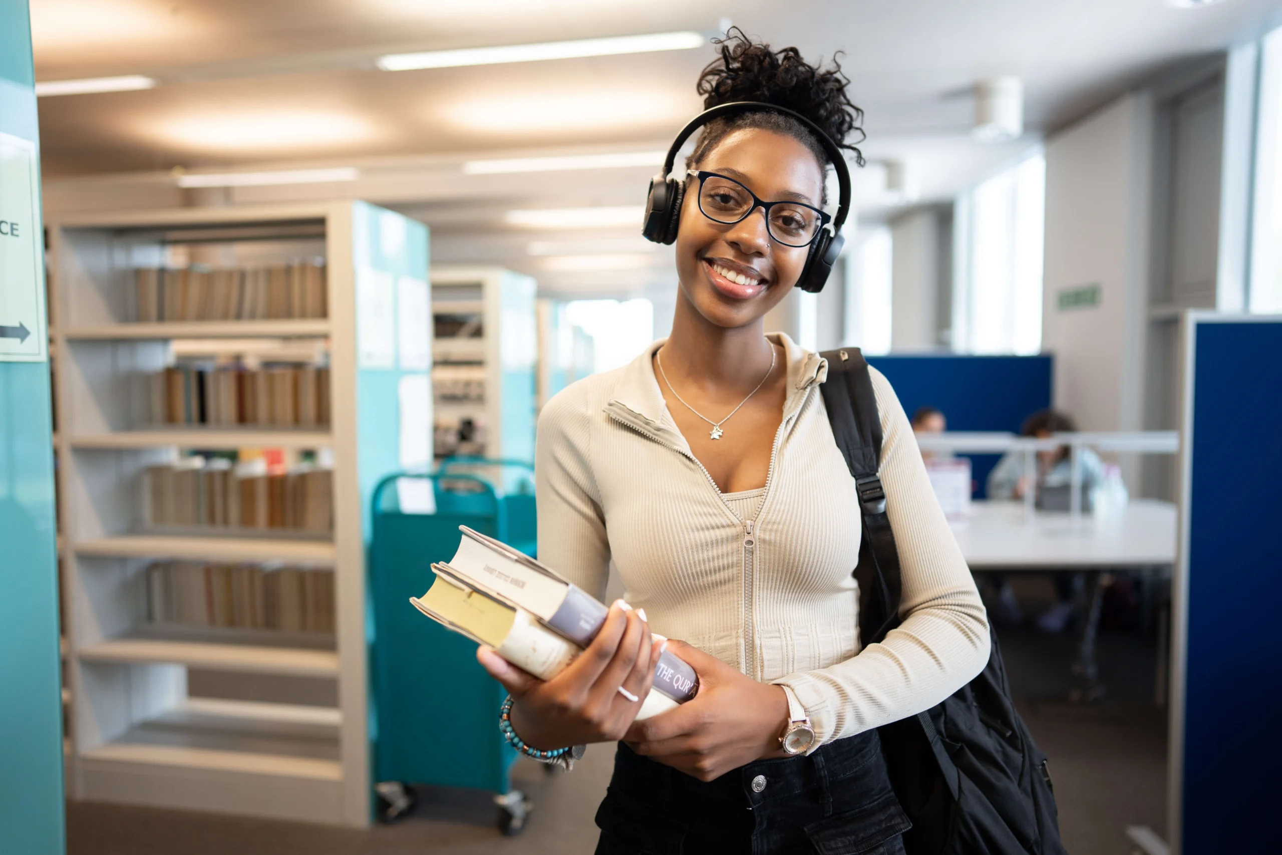 Student holding books in the library