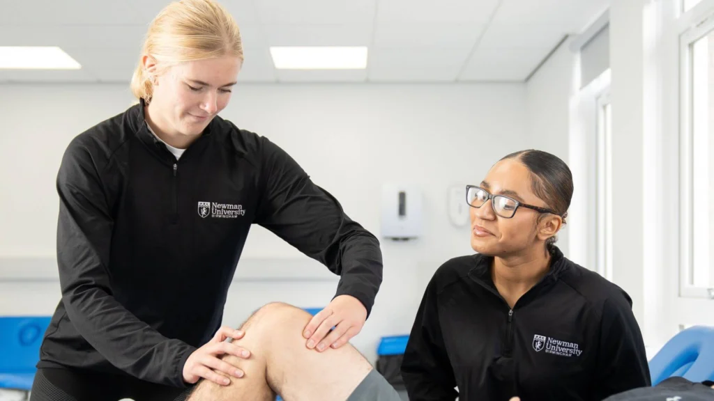 Two students at massage clinic at Birmingham Newman University