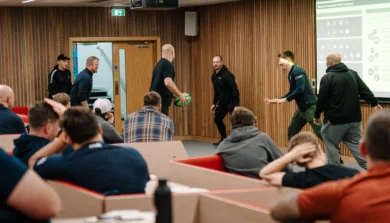 Rugby coaching event organized by North Midlands RFU, showing coaches demonstrating tackling drills and passing techniques to players