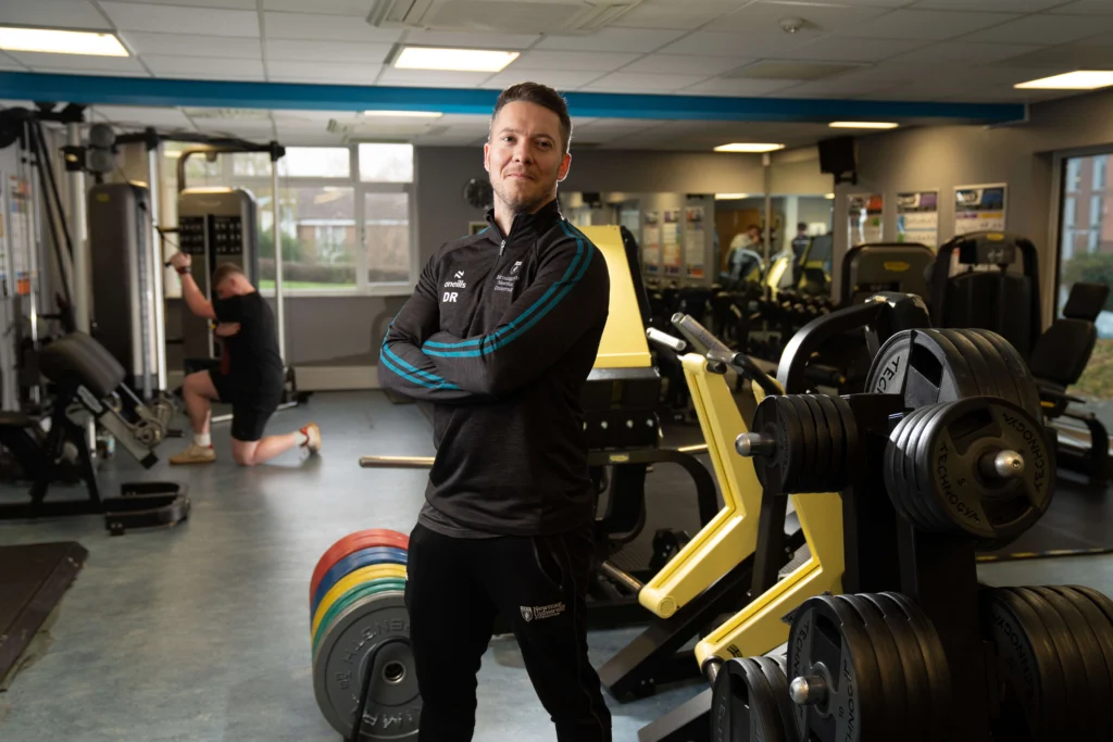 Sports and Fitness Centre staff member in gym/weights area