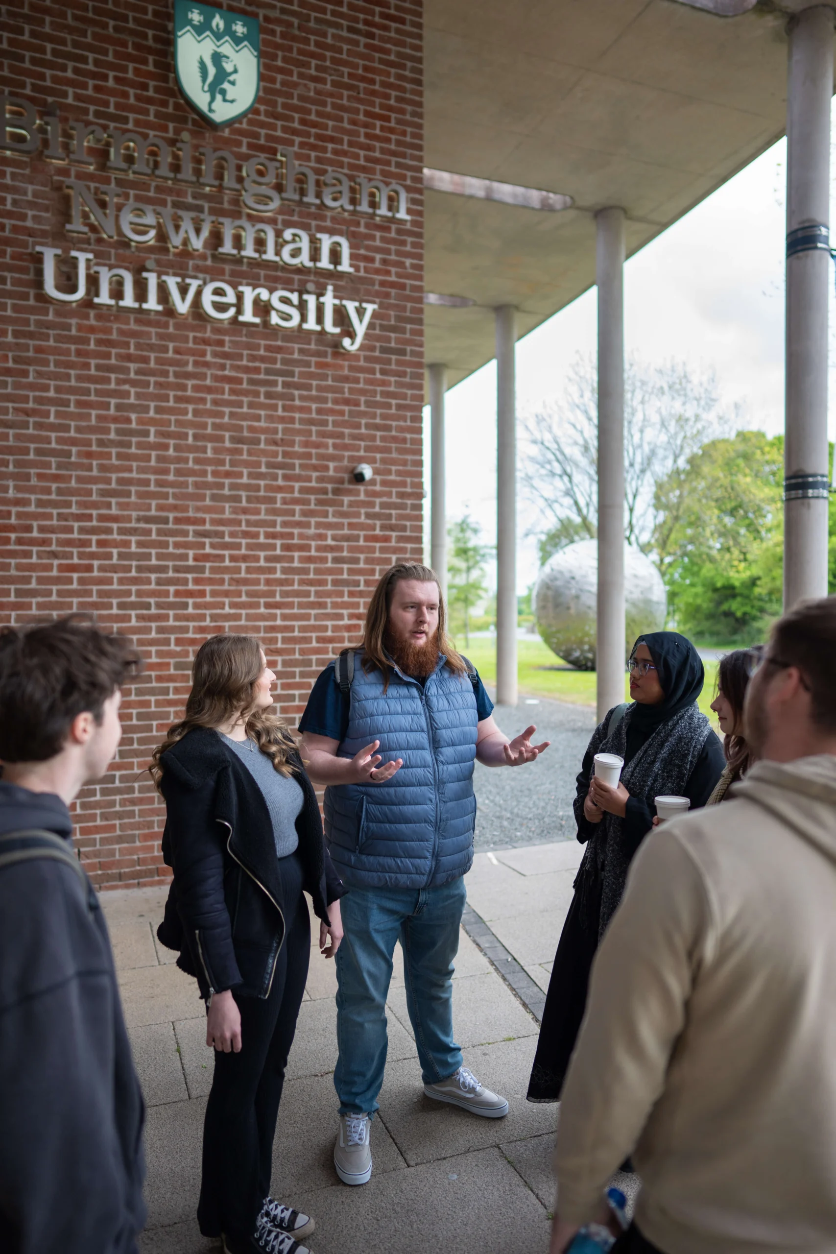 students talking in a group outside Birmingham Newman