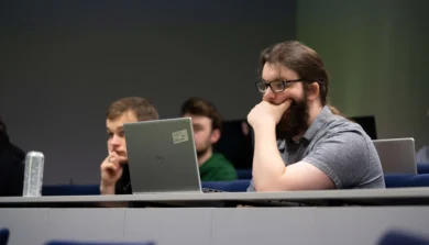 Students in lecture room with laptop