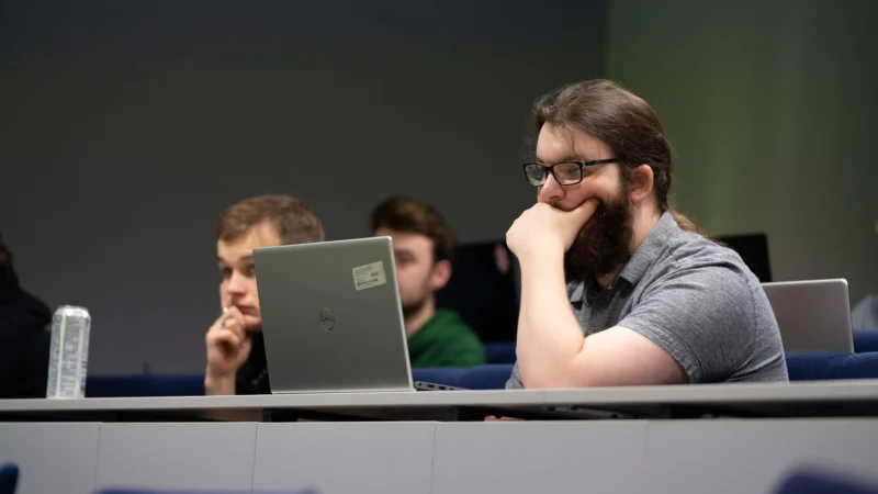 Students in lecture room with laptop