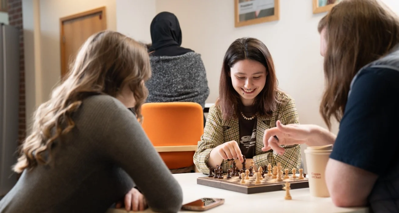 students in students union playing chess