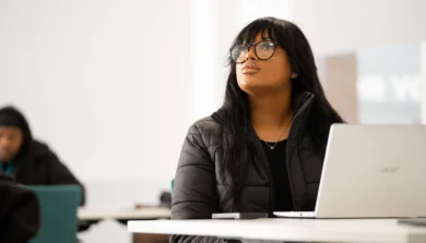 Business Management student in lecture with laptop