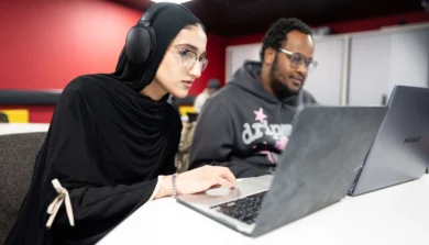 Computer Science students in class on laptop