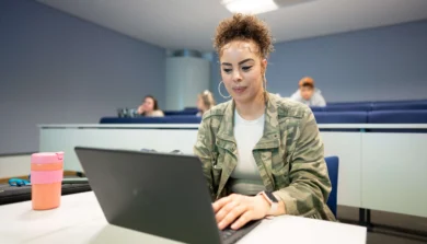 Computer Science student in class on laptop