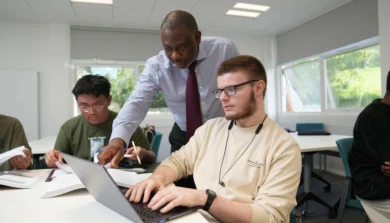 Business academic talking to students in class