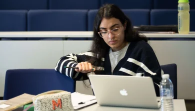 Criminology student in lesson with laptop