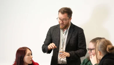 Education, Childhood and Professional Studies students in classroom with academic explaining to them