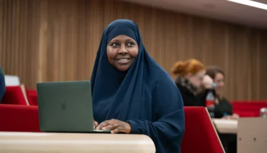 Education, Childhood and Professional Studies in lecture theatre with laptop