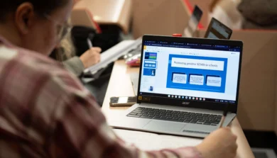 Education, Childhood and Professional Studies students in classroom with laptop